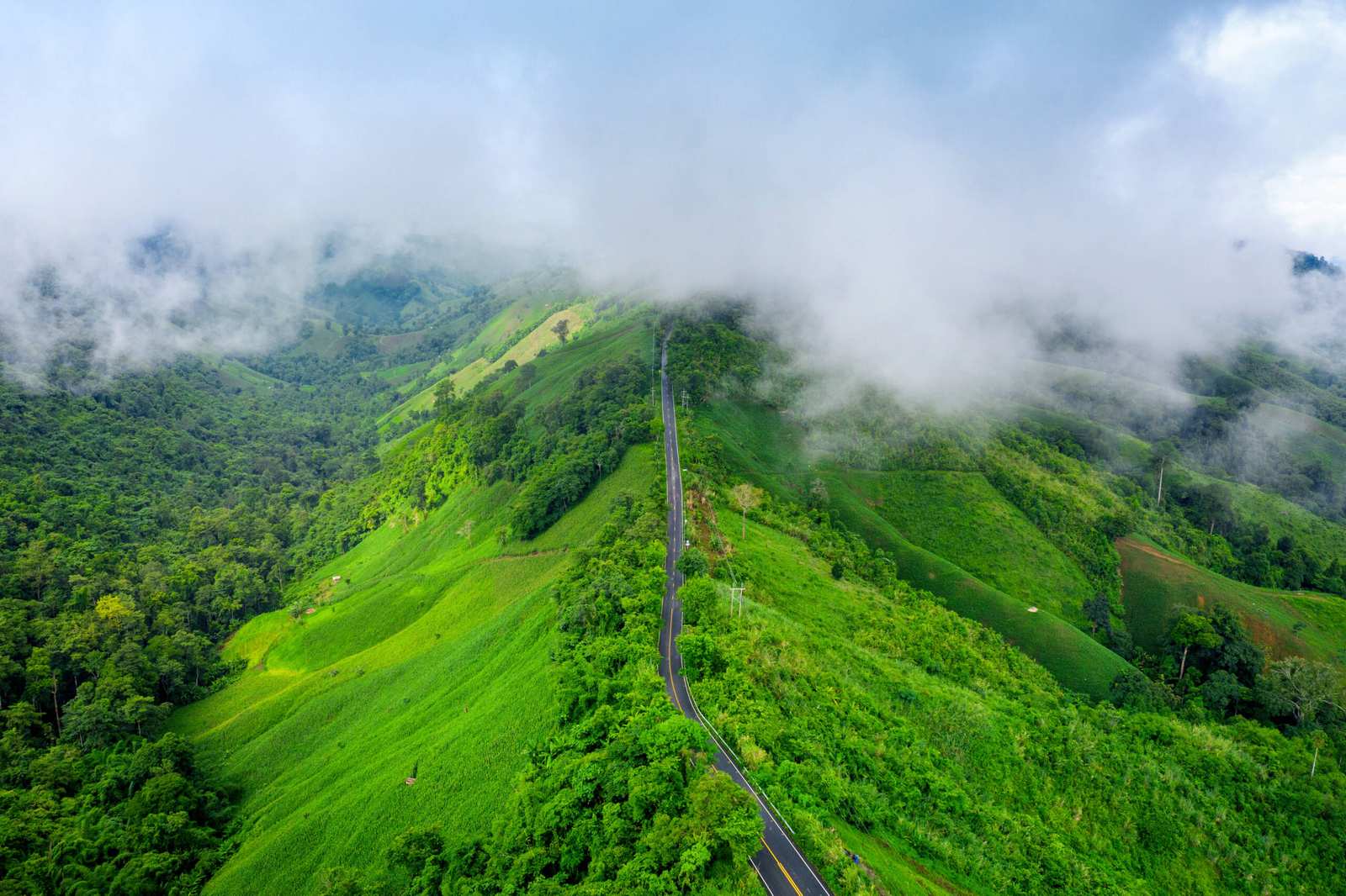 Aerial view of Beautiful sky road over top of mountains with gre Aerial view of Beautiful sky road over top of mountains with green jungle in Nan province, Thailand.