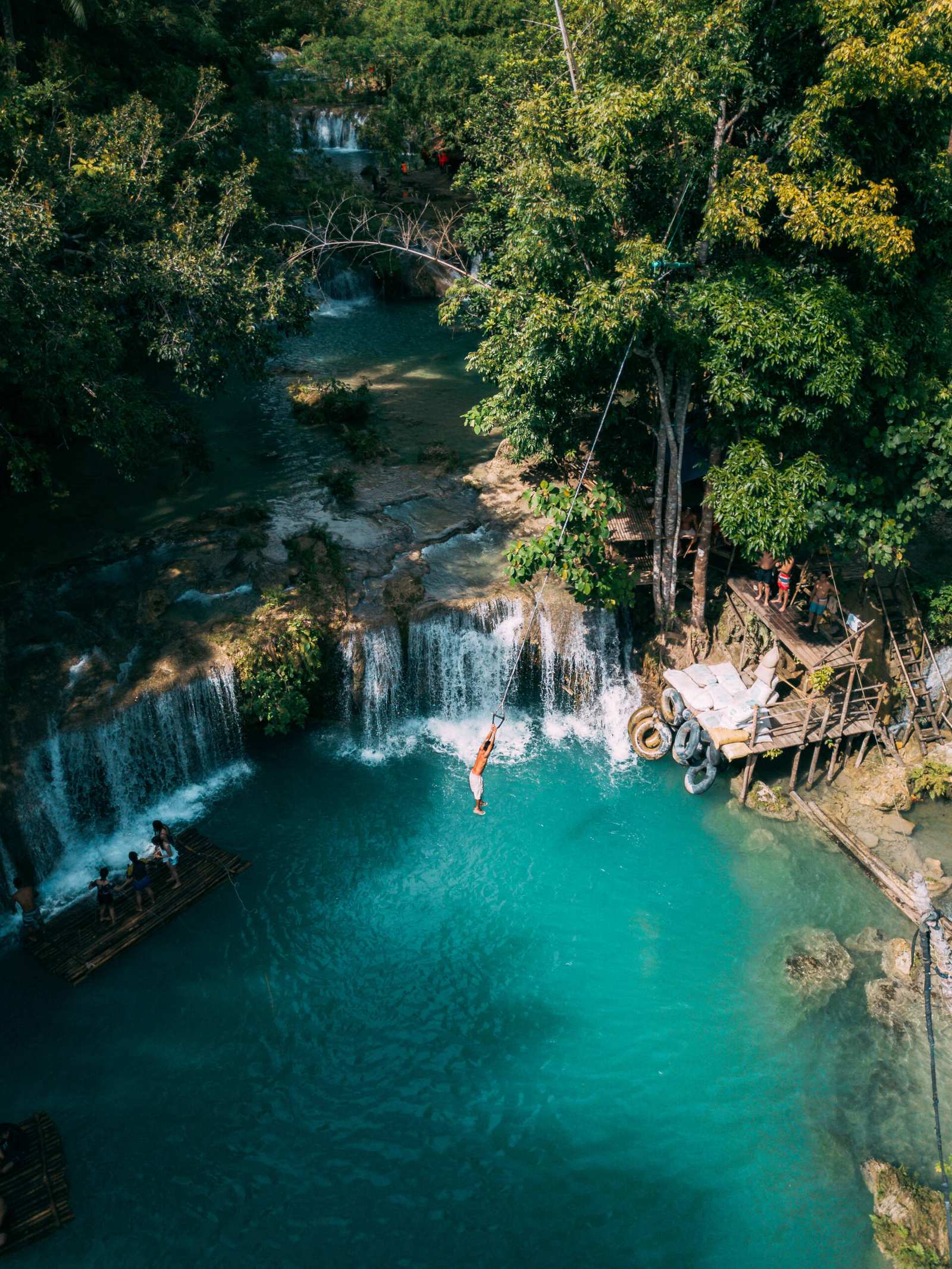 The beautiful waterfall streaming down into the river surrounded by greens
